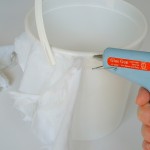 Continue gluing strips to pail until completely covered